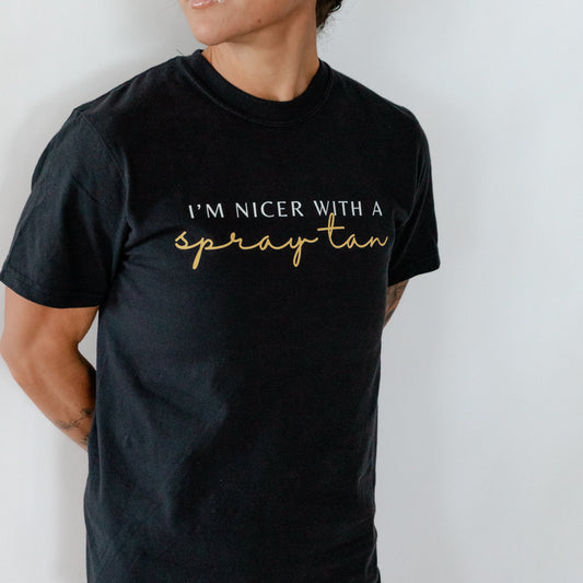 woman wearing a black shirt that says i'm nicer with a spray tan