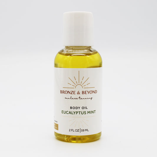Bottle of Bronze & Beyond tan safe Eucalyptus Mint body oil on a white background