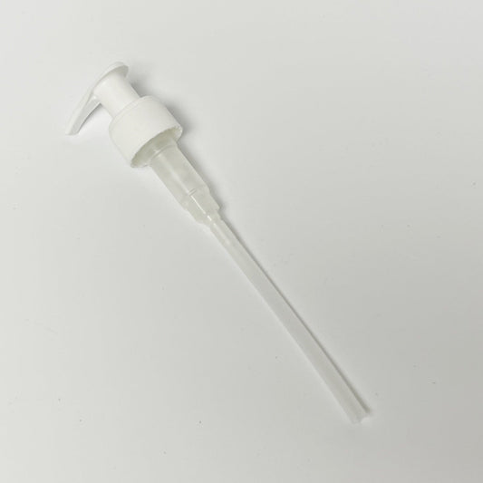 White pump dispenser on a light background